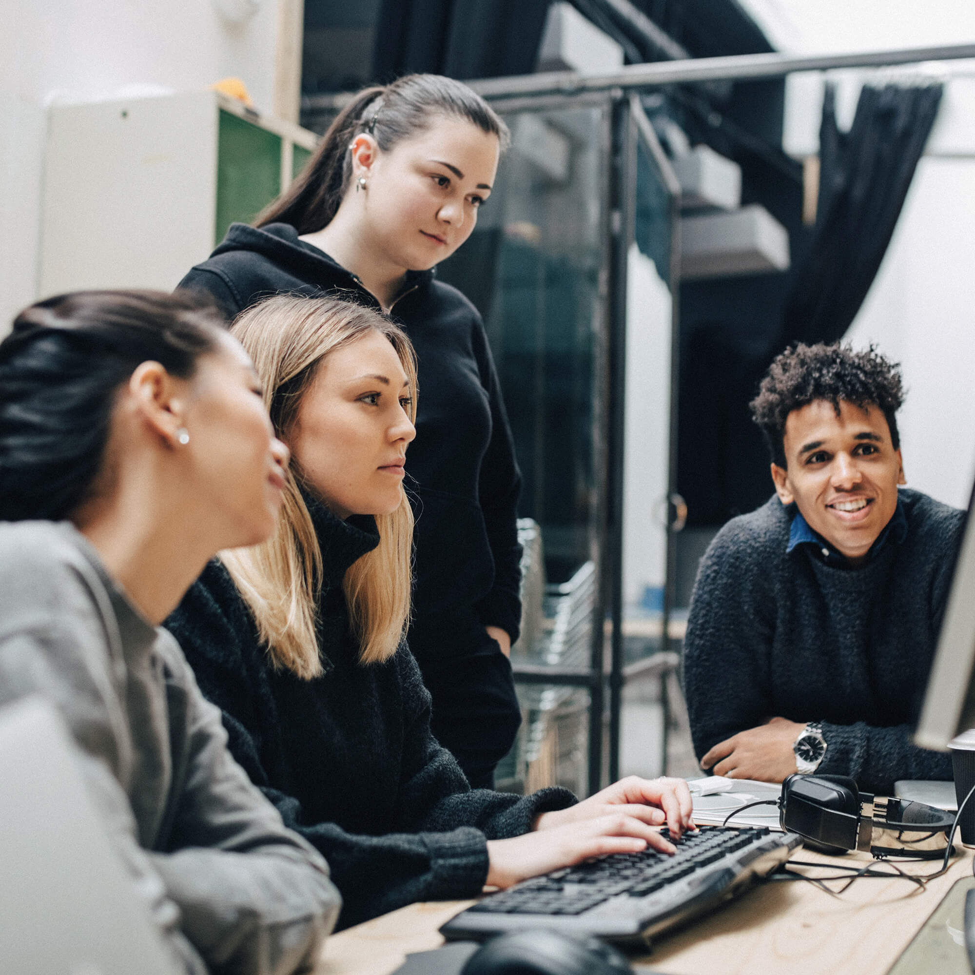 Digital collaboration of four people working together