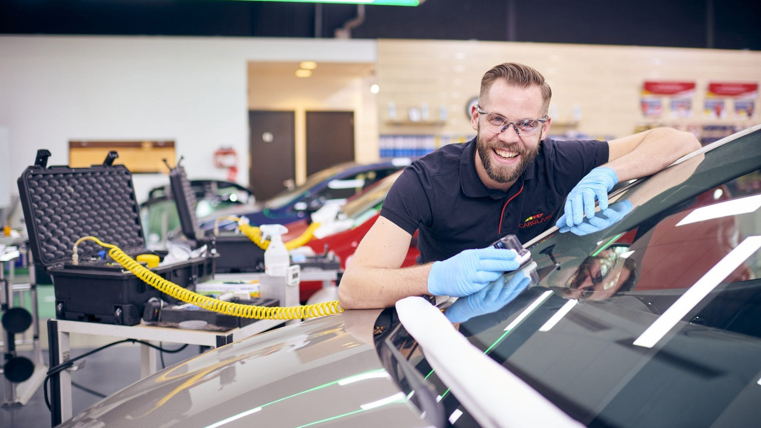 Carglass employee working on fixing a windshield