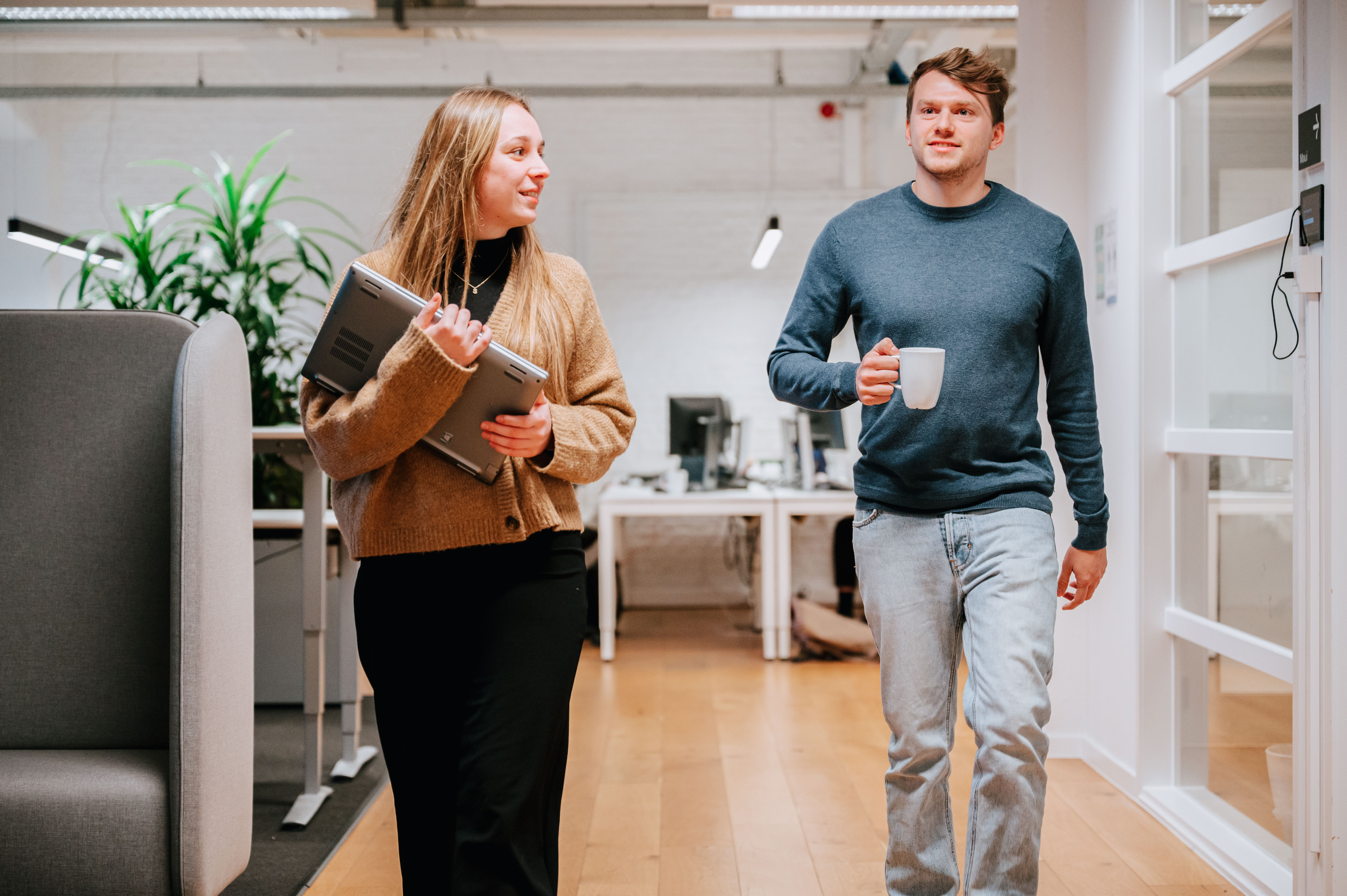 Two people walking through the Ghent office of The Reference