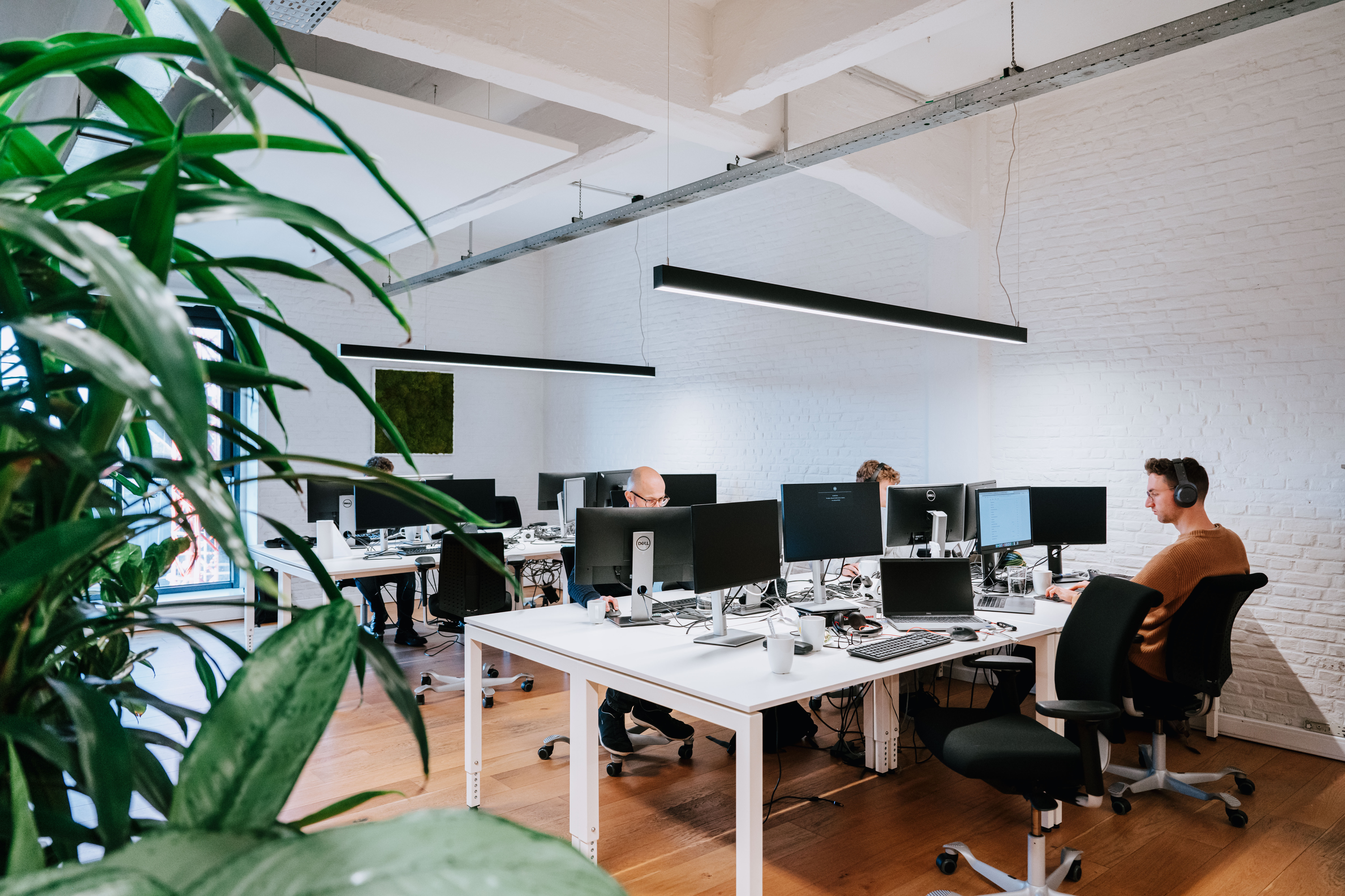 Wide shot of the office while people are working 