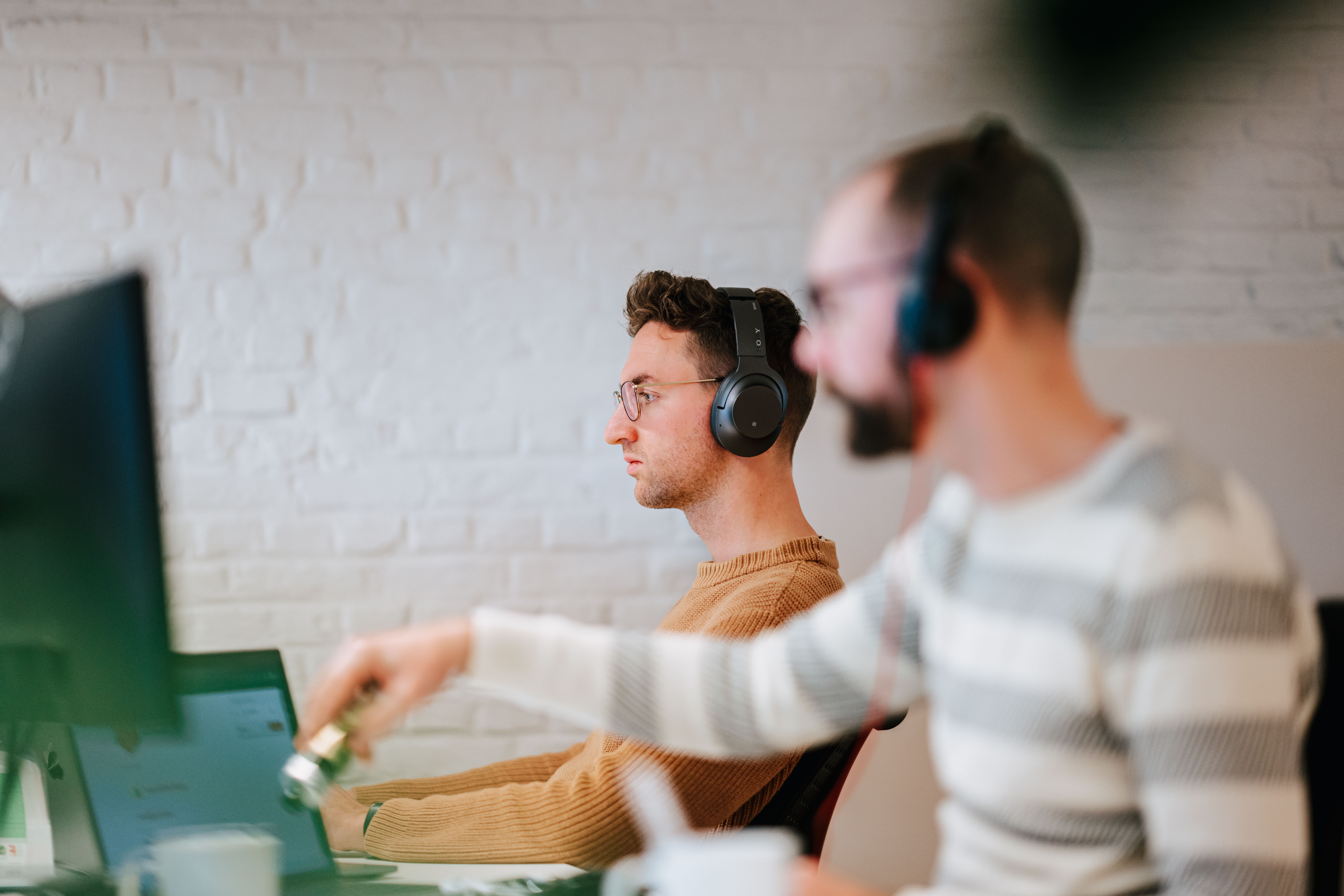 Two people working behind their desk