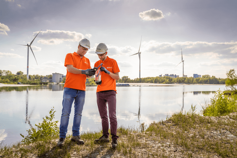 Sibelco workers standing near a river bank 