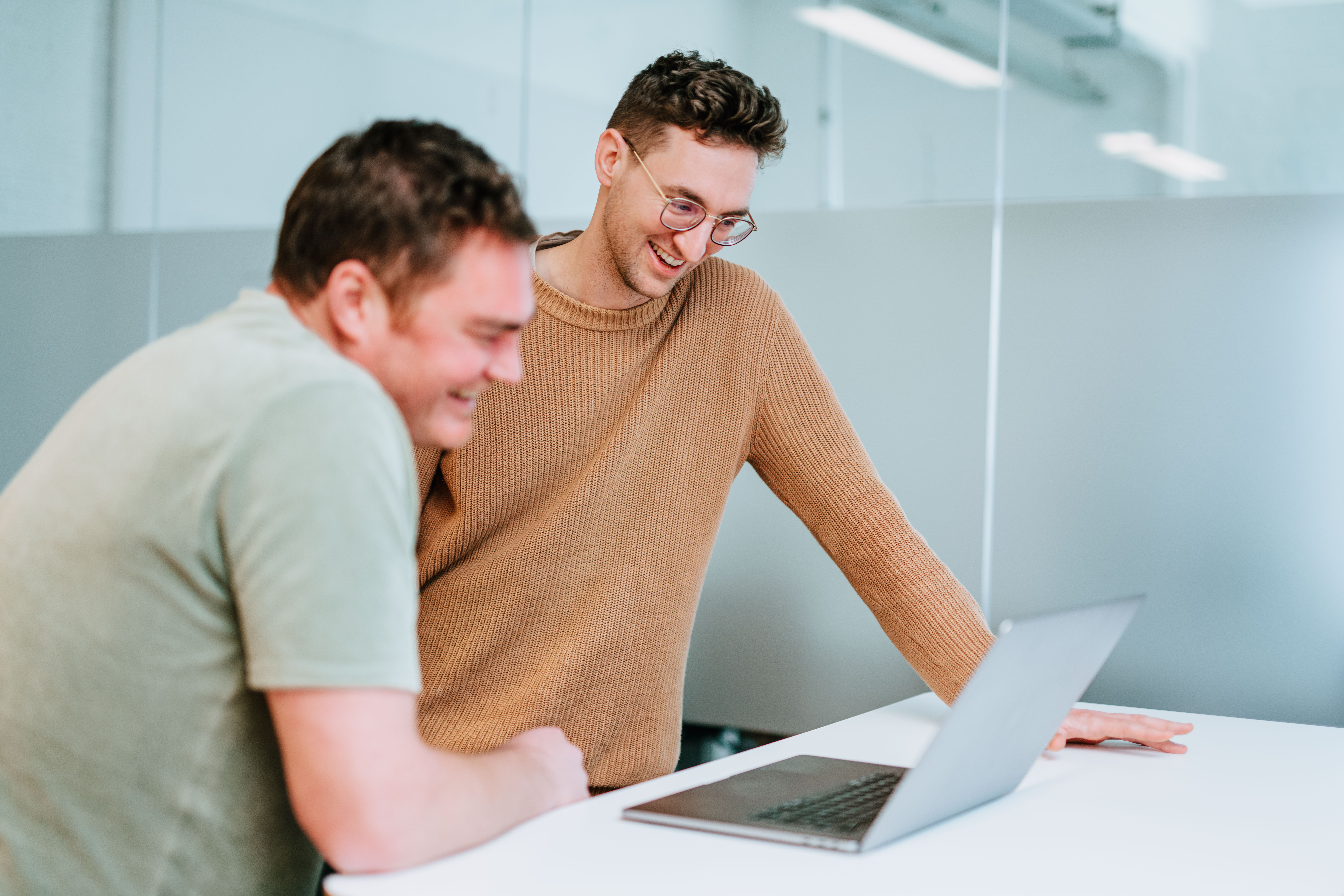 Two people in conversation, laughing