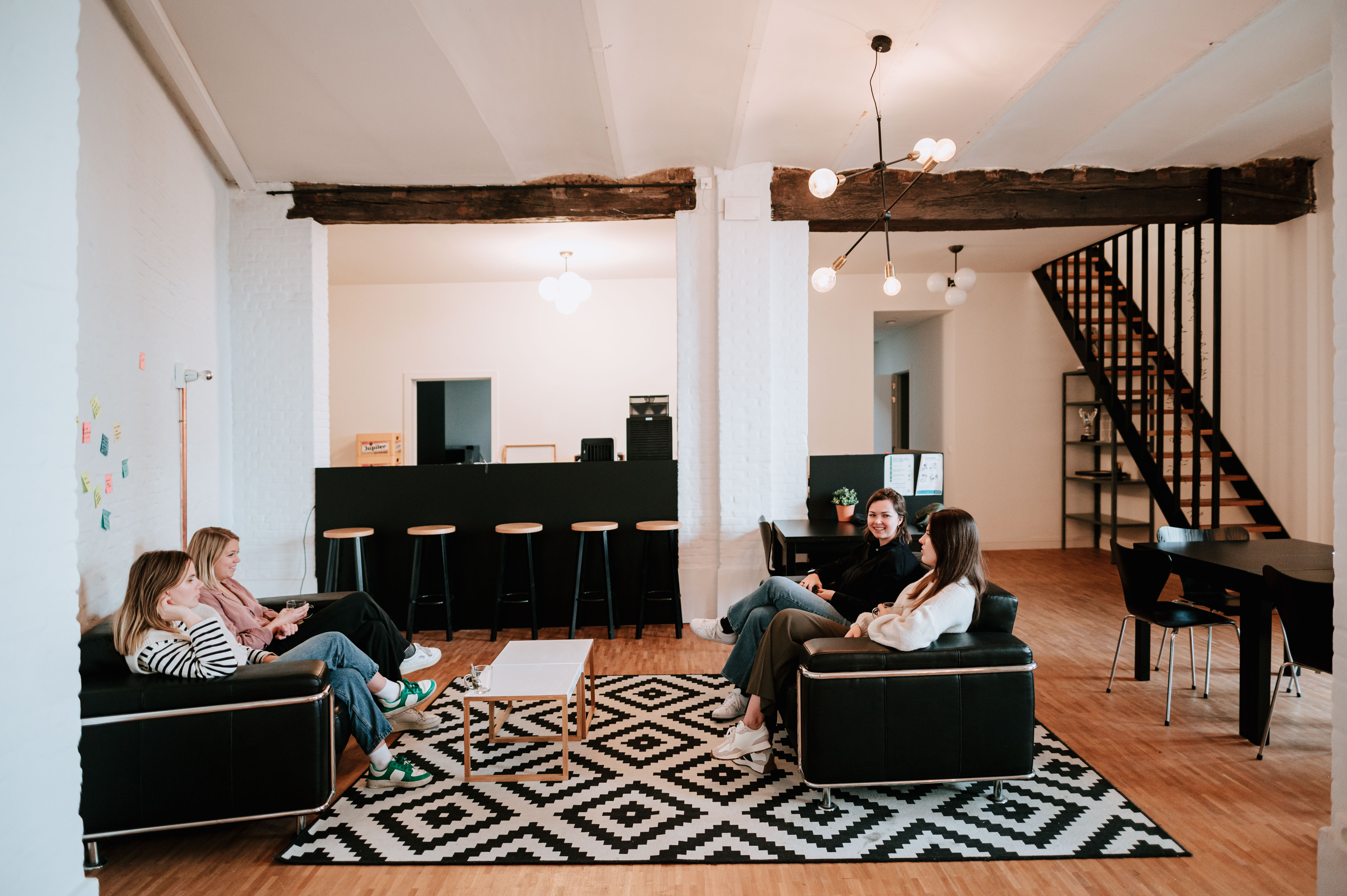 A group of people talking to each other in a couch 