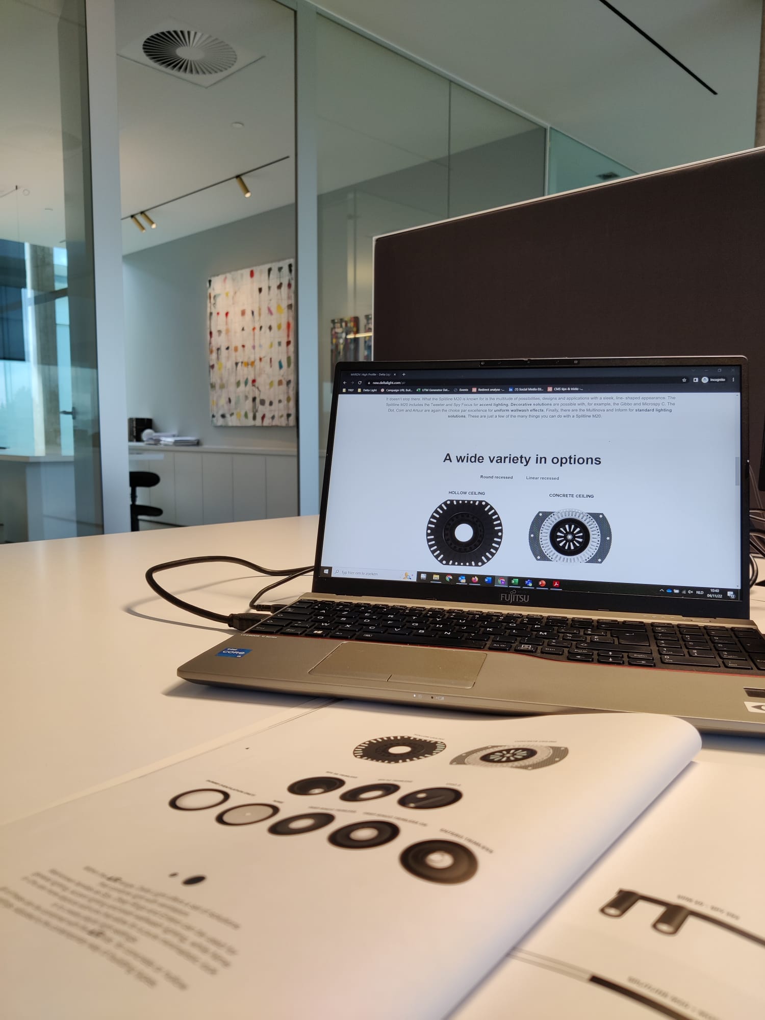 Laptop screen with product manual in front