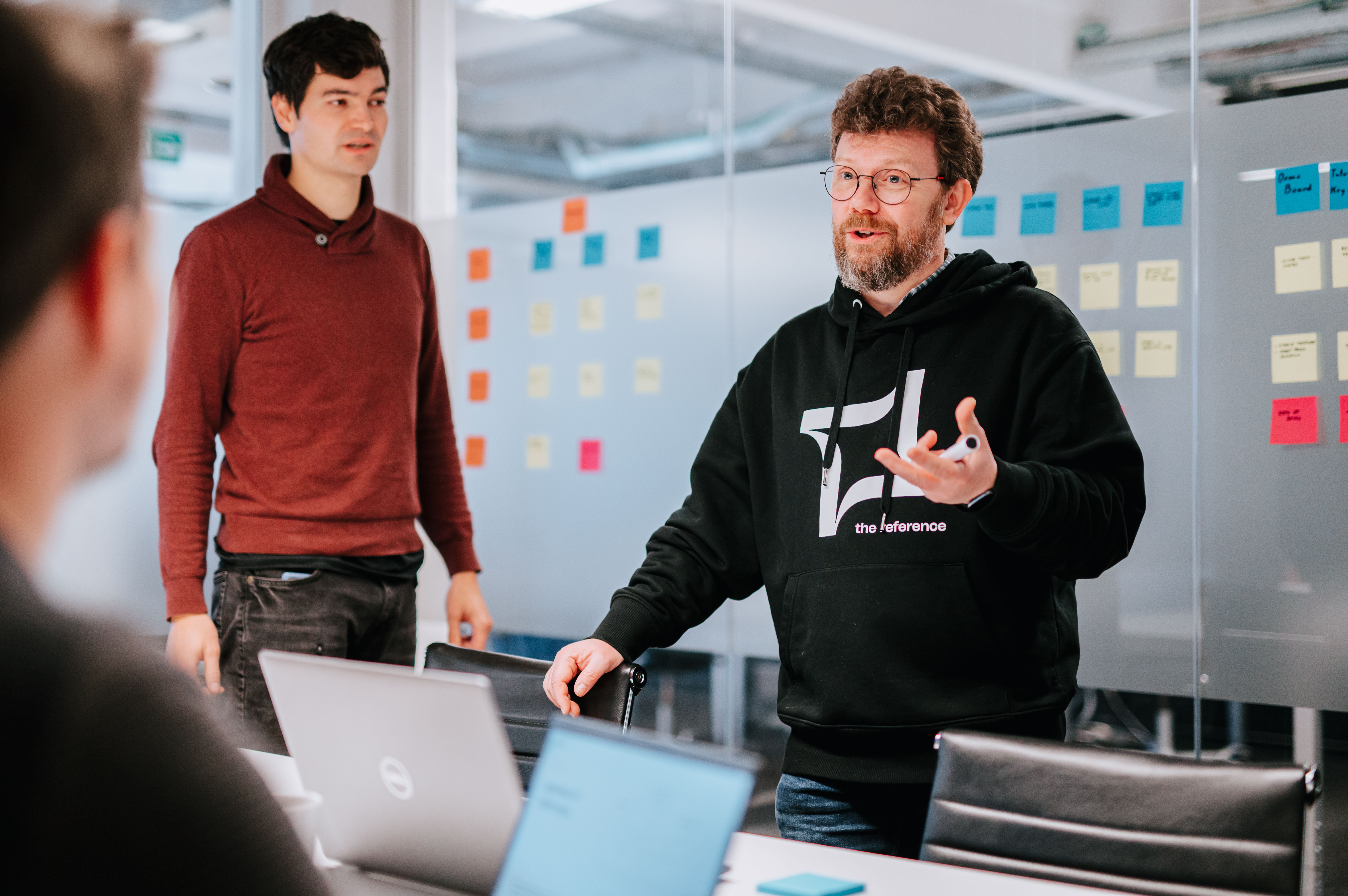 A person explaining something to his co-workers 